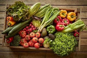 a wooden box full of vegetables